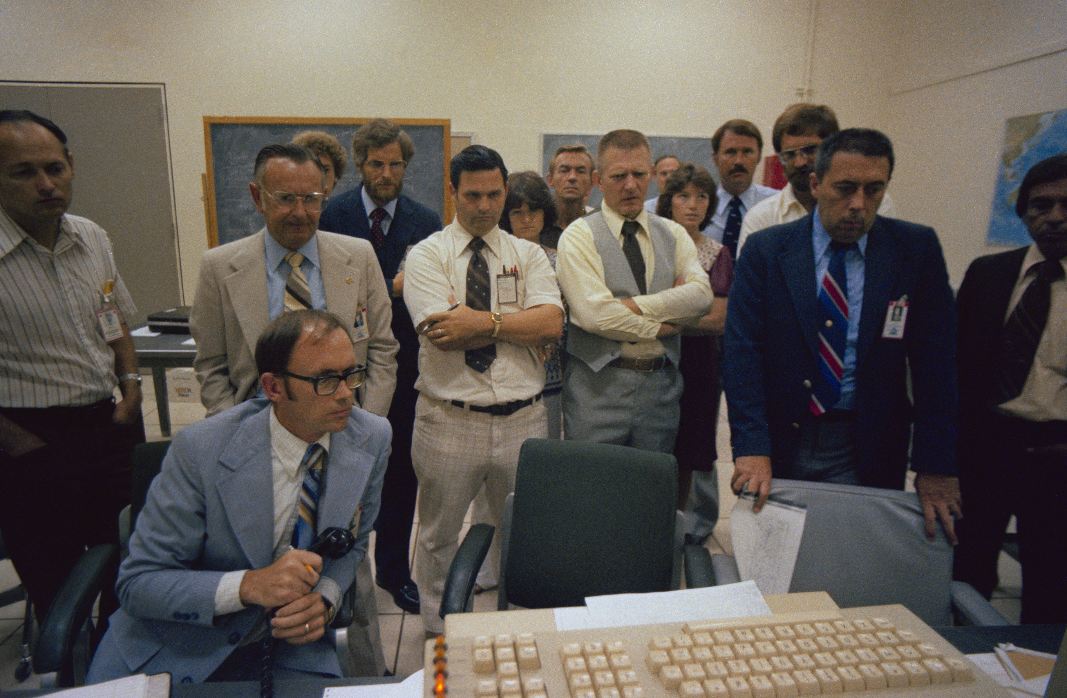 Managers, flight directors, and astronauts monitor Skylab's reentry from Mission Control at NASA's Johnson Space Center in Houston