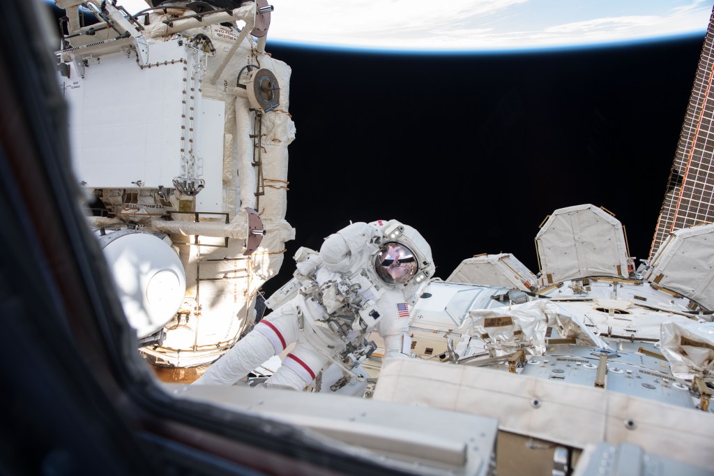 An Expedition 55 crew member inside the cupola photographed NASA astronaut Drew Feustel outside the International Space Station conducting a spacewalk with fellow NASA astronaut Ricky Arnold (out of frame) on March 29, 2018.