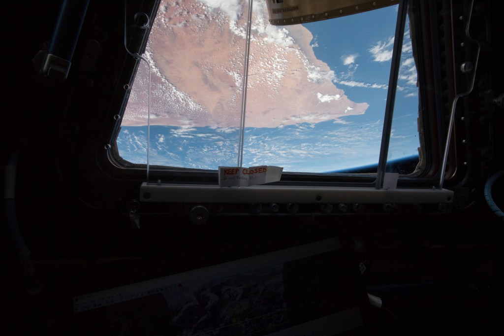 The "Horn of Africa" is seen through one of the seven windows that make up the Cupola, a dome-shaped module on the International Space Station. The space station crew will be inside the Cupola Wednesday morning operating a robotics workstation to capture the upcoming SpaceX Dragon.