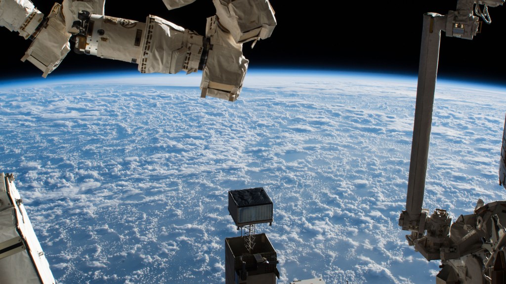 The International Space Station was orbiting 256 miles above the North Pacific Ocean and about 600 miles south of Alaska's Aleutian Islands. In the foreground, are portions of two major space station robotic systems. At right, is the Japanese robotic manipulator system which is attached to the Kibo laboratory module. At upper left, is part of the Canadian robotic manipulator system which can maneuver along various points on the space station.