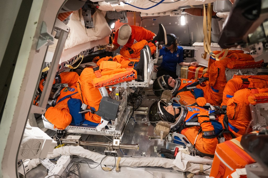 The Artemis II crew trains for post landing emergency egress inside the Orion Mockup in Building 9 at NASA's Johnson Space Center. On the top left is Pilot Victor Glover of NASA and Commander Reid Wiseman of NASA. On the bottom right are Mission Specialist's Christina Koch of NASA and Jeremy Hansen of CSA (Canadian Space Agency). Credit: NASA/James Blair