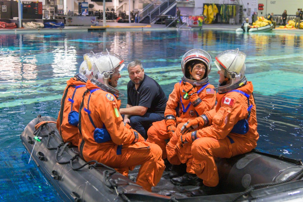 The Artemis II crew seated together on an inflatable during their Orion Water Survival Demo in the Neutral Buoyancy Laboratory. Credit: NASA/Josh Valcarcel