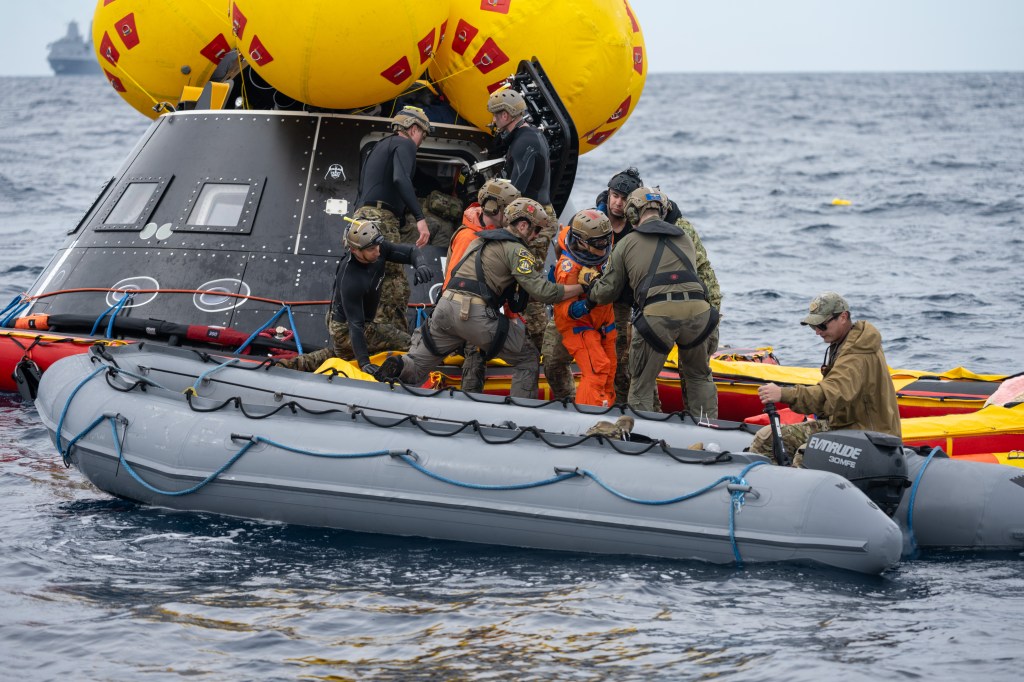 NASA Artemis II crew members are assisted by U.S. Navy personnel as they exit a mockup of the Orion spacecraft in the Pacific Ocean during Underway Recovery Test 11 (URT-11) on Feb. 25, 2024. Credit: NASA/Kenny Allen