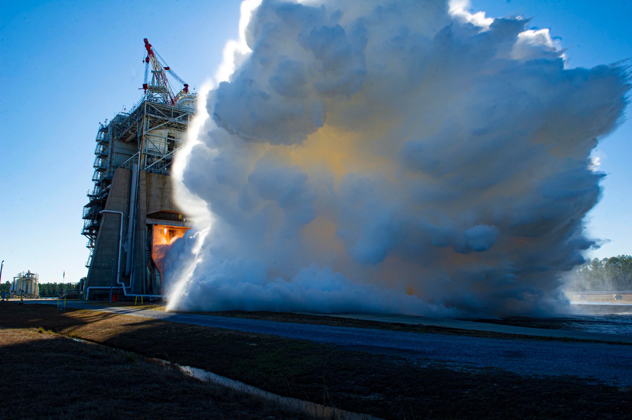 banner image for capabilities and services; vapor clouds erupt towards the sky during an rs-25 hot fire