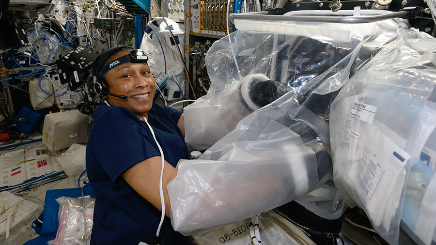 Astronaut Jeanette Epps works in the BioFabrication Facility portable glovebag to print cardiac cell samples for the Redwire Cardiac Bioprinting Investigation.