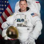 jsc2018e037944_alt2 (May 31, 2018) --- Official portrait of NASA astronaut Nick Hague in a U.S. spacesuit, also known as an Extravehicular Mobility Unit (EMU).