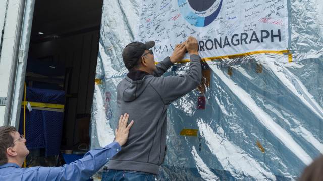 Team members at JPL said farewell to the Roman Coronagraph Instrument on May 17 by signing their names to a flag (featuring the mission logo) on the outside of the shipping container that carried the instrument to NASA's Goddard Space Flight Center.
