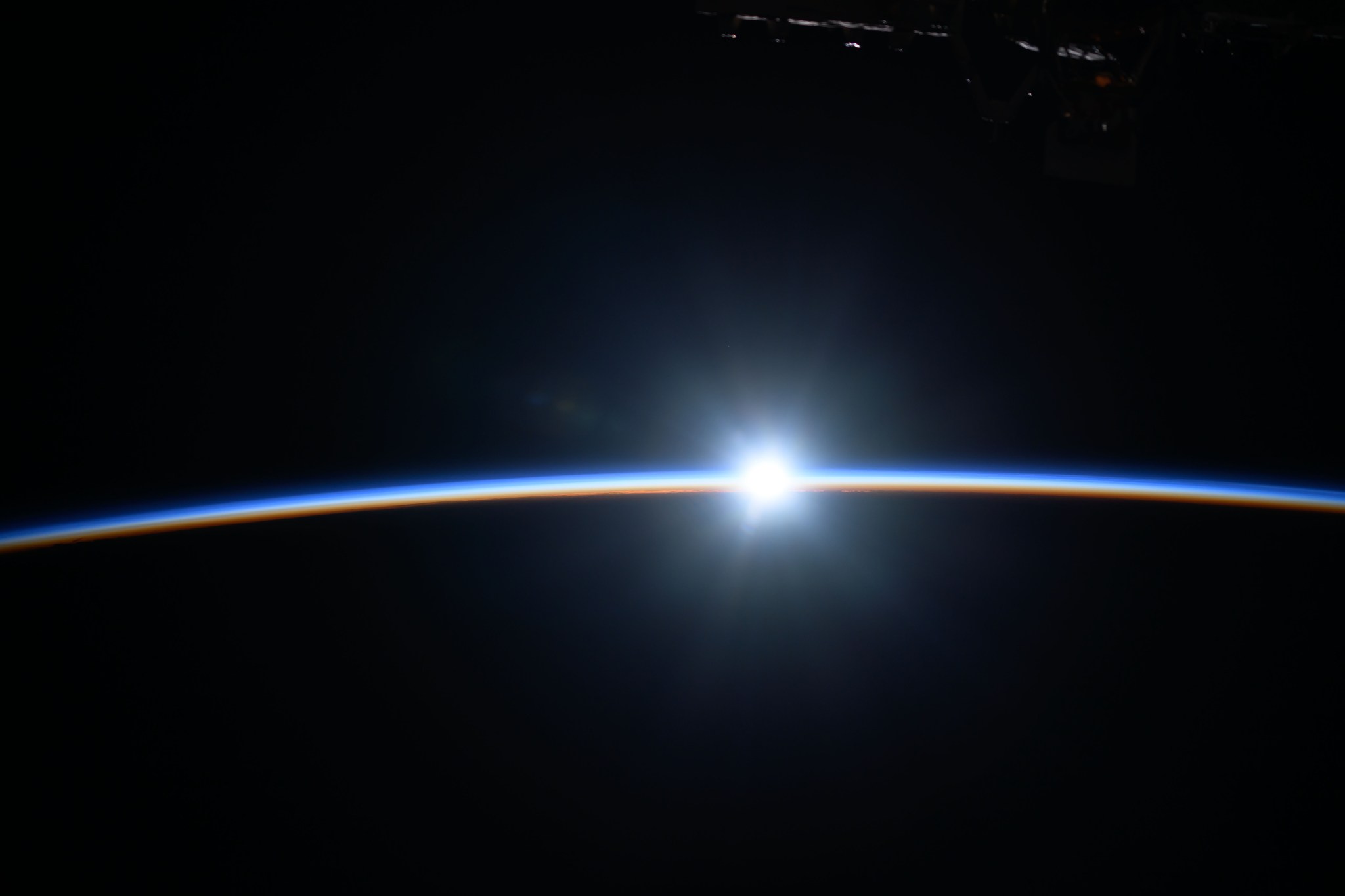 The last rays of an orbital sunset shine like a diamond while fading below Earth's atmosphere as the International Space Station soared 263 miles above the Pacific Ocean off the east coast of New Zealand.