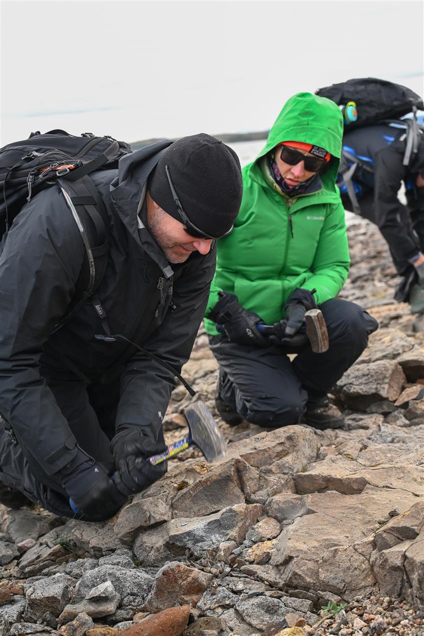 Artemis II crewmembers Jeremy Hansen and Christina Koch sample rocks using rock hammers during a field geology training expedition in northern Labrador, Canada. Credit: CSA