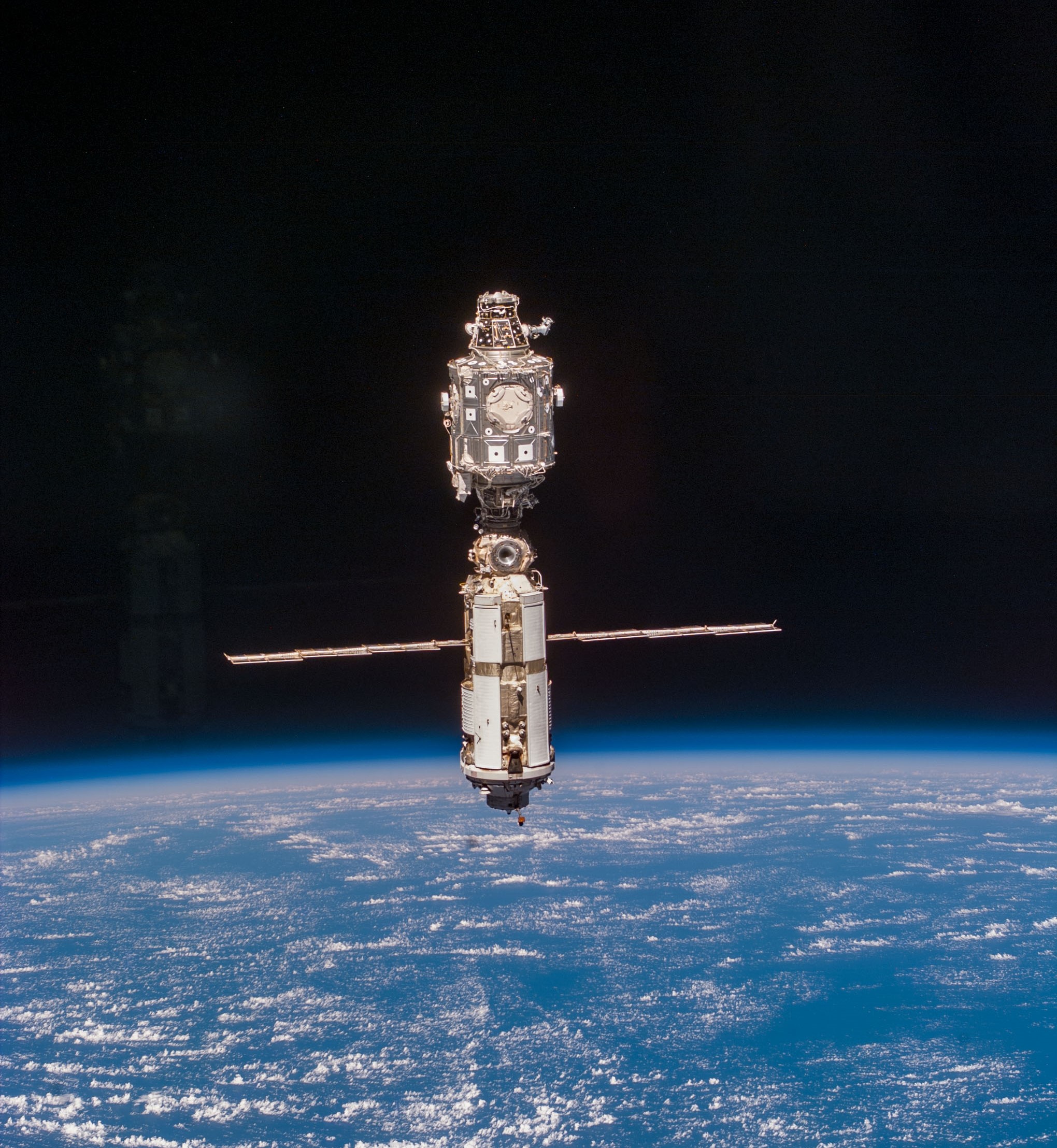 A resupplied and refurbished space station as seen from Discovery during its departure.