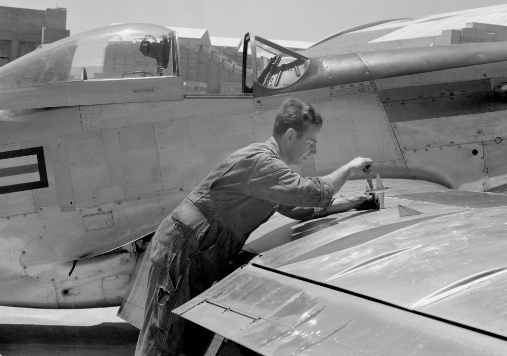 Man working on aircraft wing.