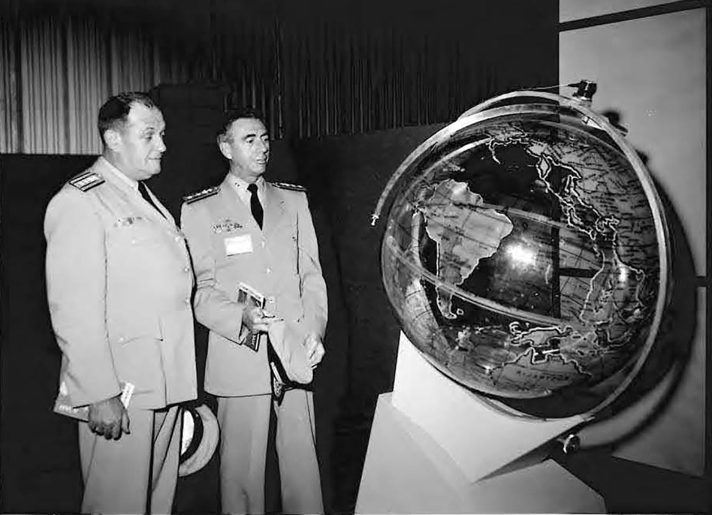 Two men looking at globe.
