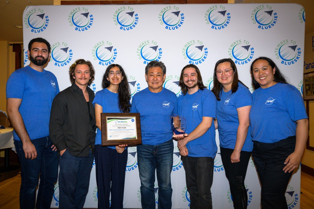 Pictured here are the first place winners of the 2024 Gateways to Blue SkiesAdvancing Aviation for Natural Disasters, which was hosted at Ames Research Center. They are wearing jeans and blue t-shirts. In no order, Nicole Xie, Krishi Gajjar, Leara Dominguez, Gerald McAllister, Junaid Bodla, Jordan Ragsac, and Masayuki Gonda.