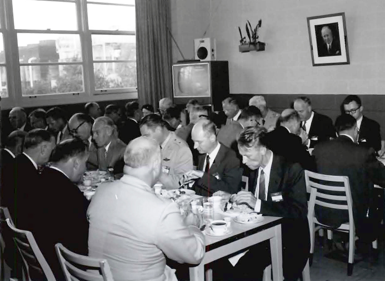 People seated in cafeteria.