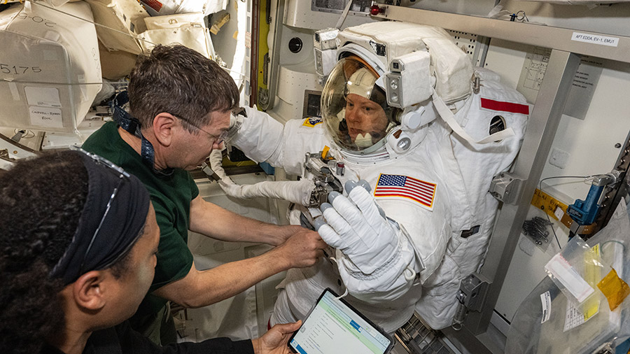 Atronauts (from left) Jeanette Epps and Mike Barratt assist astronaut Tracy C. Dyson during a spacesuit fit check inside the Quest airlock on May 30.