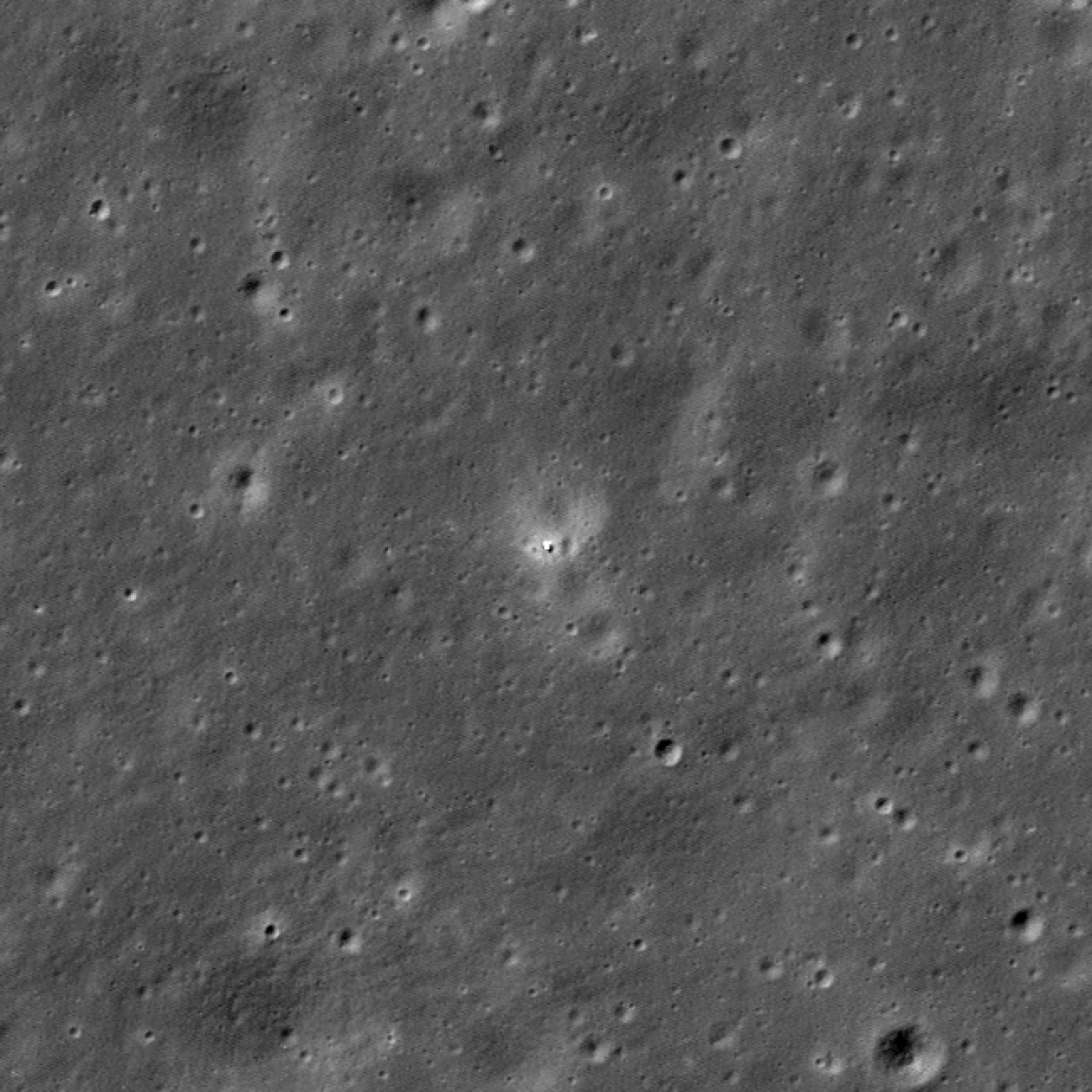 A black and white image of the surface of the Moon taken from NASA's LRO showing a white dot that is China's Chang'e 6 lander in the Apollo basin. 