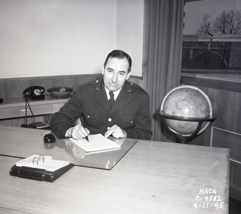 Man seated at desk.