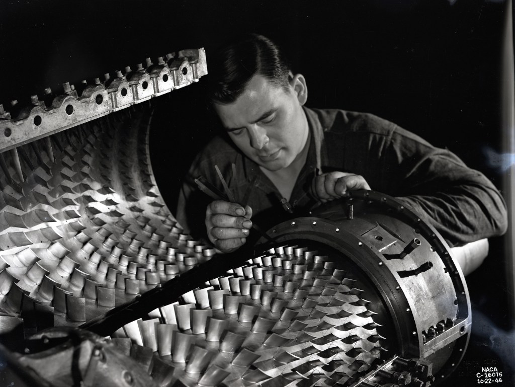 Man looking at compressor blades.