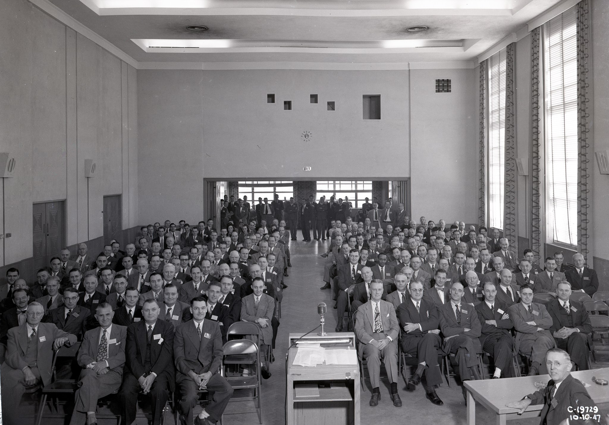 Group of people seated in auditorium.