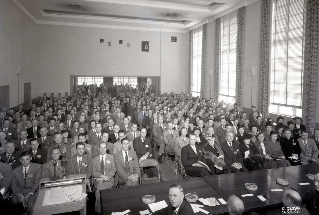 Group of people seated in auditorium.