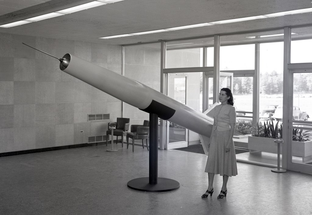 Woman with missile model.