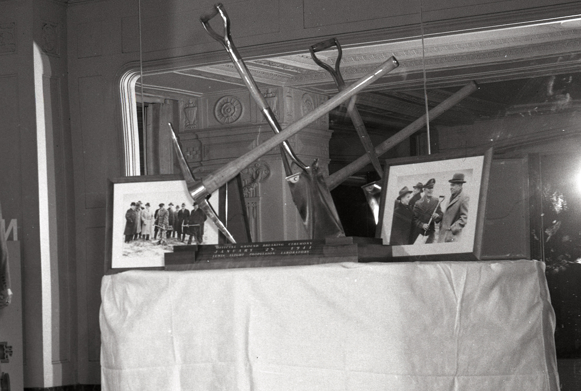 Table with pick and shovel and photographs displayed.