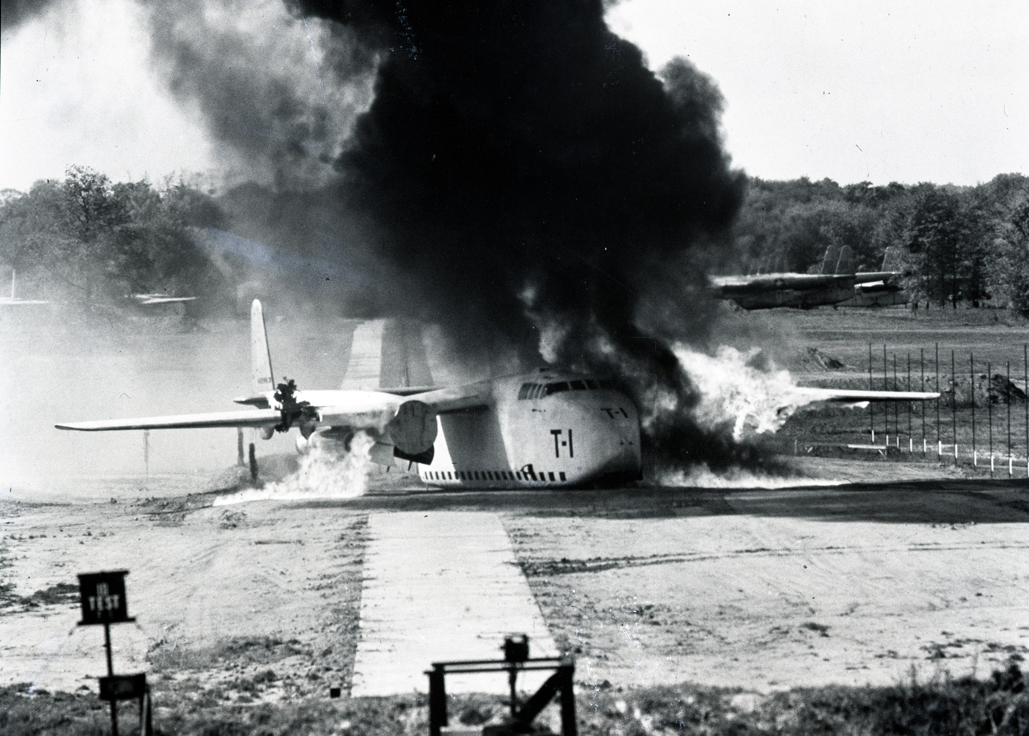 Aircraft on runway with smoke.