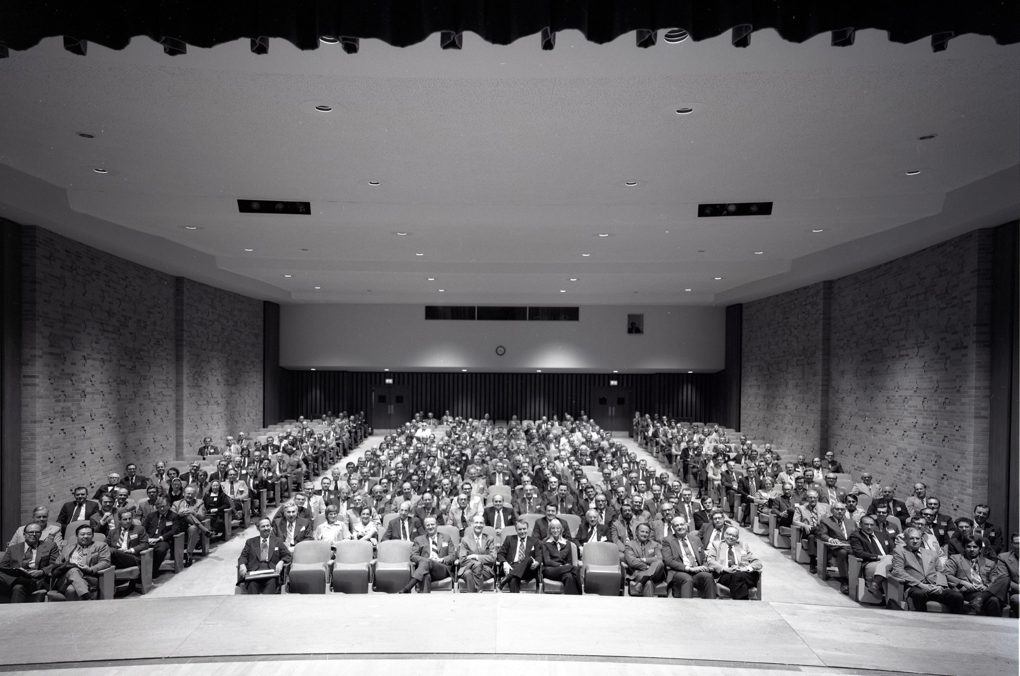 Crowd seated in auditorium.