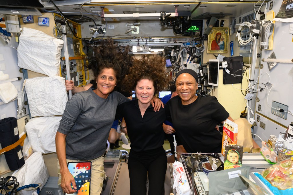 NASA astronauts (from left) Suni Williams, Tracy C. Dyson, and Jeanette Epps pose for a portrait during dinner time aboard the International Space Station's Unity module. Williams is the pilot for NASA's Boeing Crew Flight Test and Dyson and Epps are both Expedition 71 Flight Engineers.