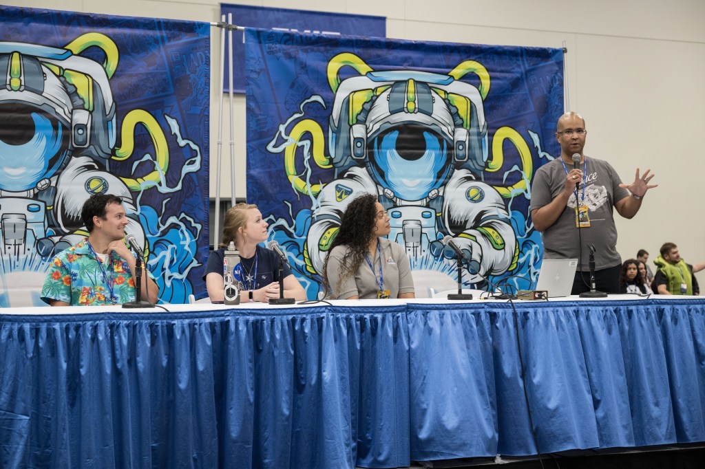 A diverse group of five panelists speaks at Comicpalooza.
