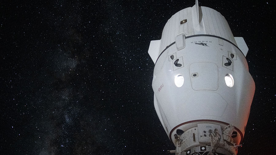 The Milky Way appears in the vastness of space behind the SpaceX Dragon Endeavour spacecraft docked to the space station's Harmony module.