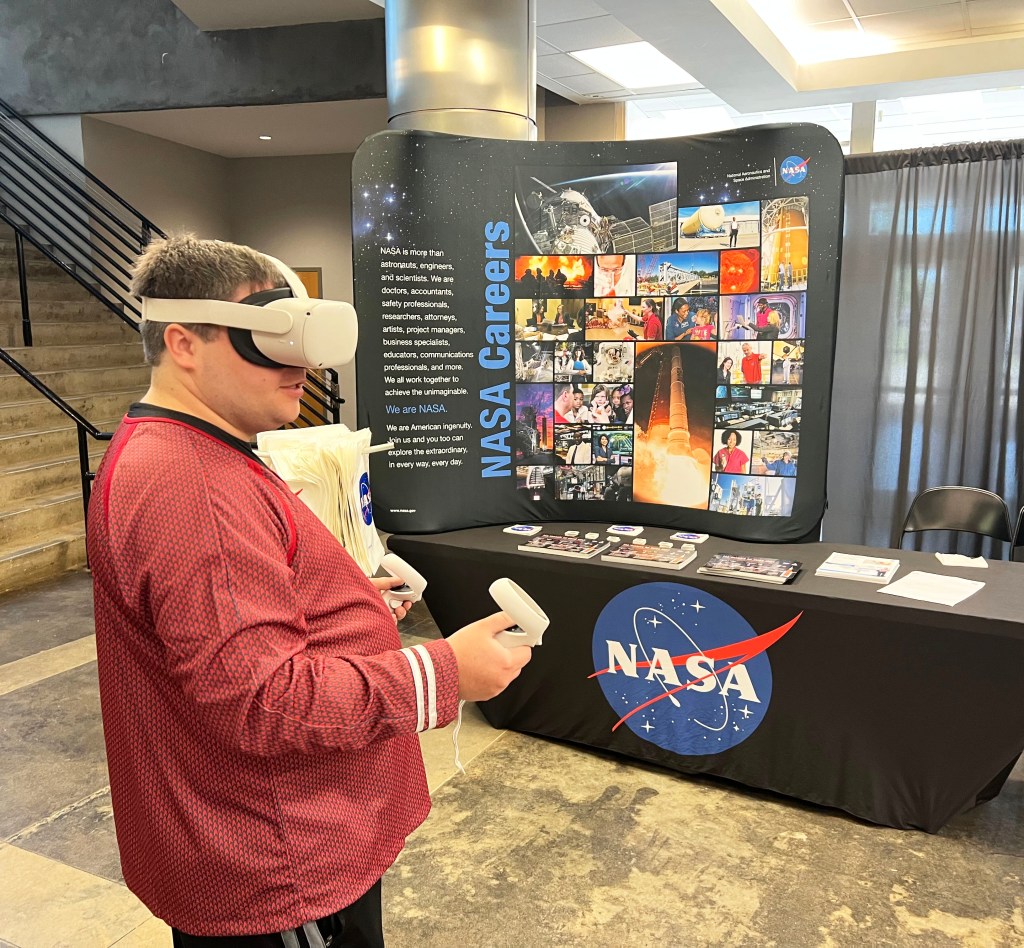 Man uses virtual reality device while visiting the NASA Stennis booth