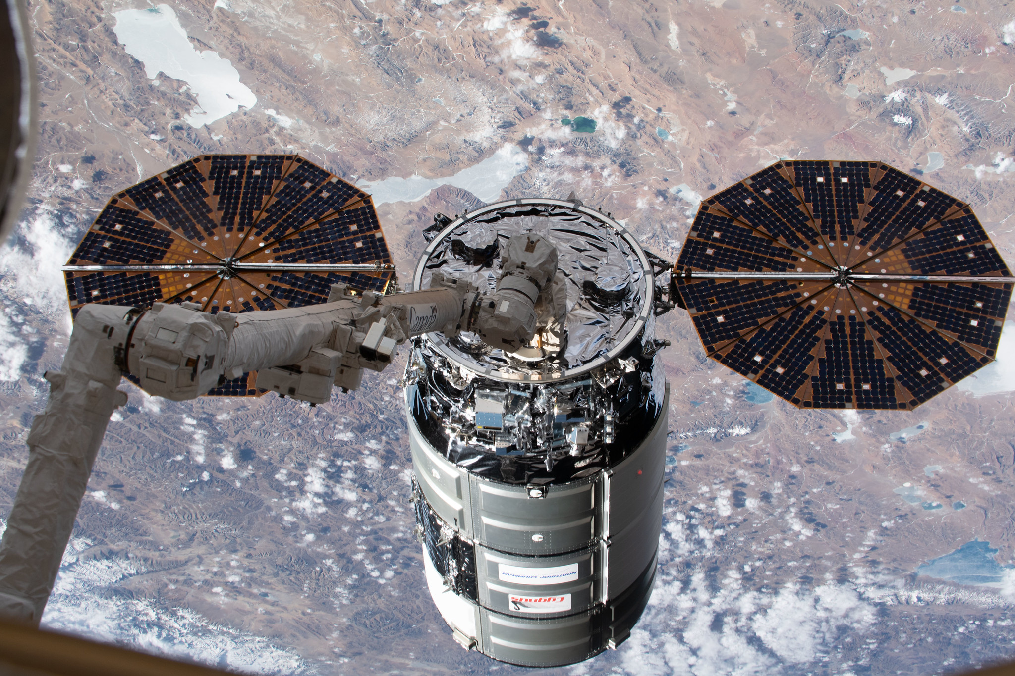 An image of Northrop Grumman’s Cygnus spacecraft in the grips of the Canadarm2 robotic arm shortly after being captured at the International Space Station