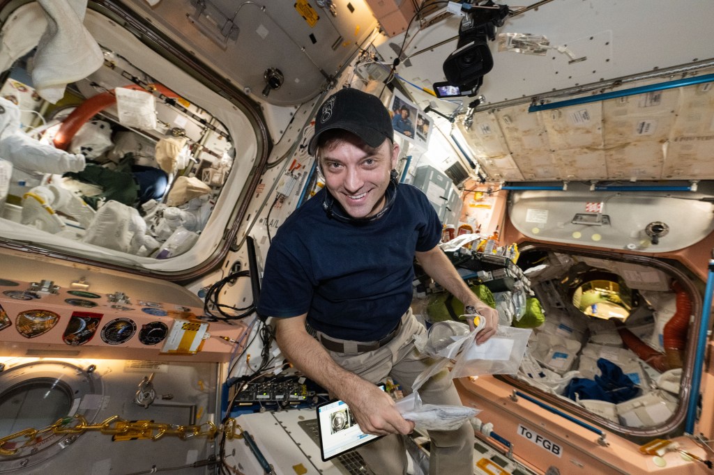 NASA astronaut and Expedition 71 Flight Engineer Matthew Dominick is pictured inside the Unity module after preparing Northrop Grumman's Cygnus space freighter for its depressurization and departure from the International Space Station. At left, is the Quest airlock where astronauts service spacesuits and stage spacewalks. To the right, is the vestibule in between Unity and the Zarya module that leads to the orbital outpost's Roscosmos segment.
