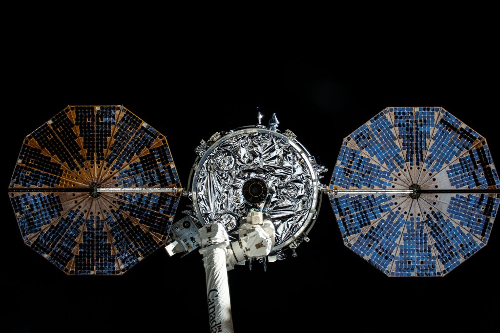 iss071e329920 (July 12, 2024) -- Northrop Grumman's Cygnus space freighter and its two cymbal-shaped solar arrays is pictured attached to the Canadarm2 robotic arm ahead of its release from the International Space Station's Unity module on July 12, 2024.