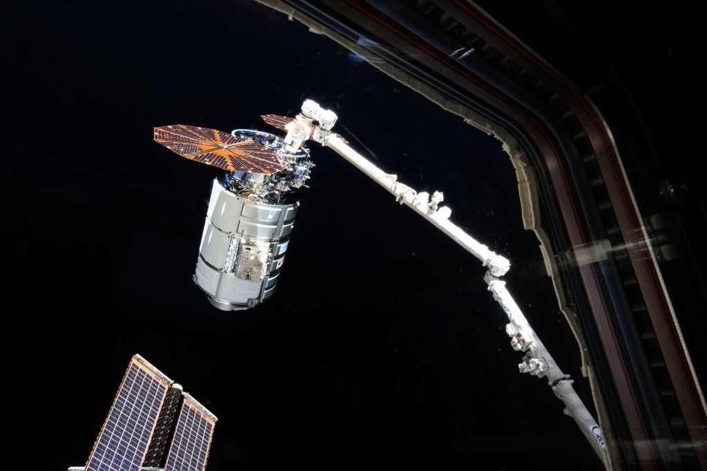 Northrop Grumman's Cygnus space freighter is pictured attached to the Canadarm2 robotic arm ahead of its release from the International Space Station's Unity module.