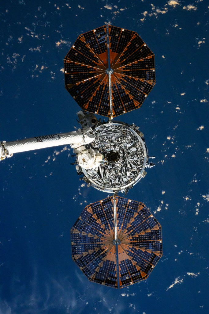 Northrop Grumman's Cygnus space freighter and its two cymbal-shaped solar arrays is pictured attached to the Canadarm2 robotic arm ahead of its release from the International Space Station's Unity module on July 12, 2024.