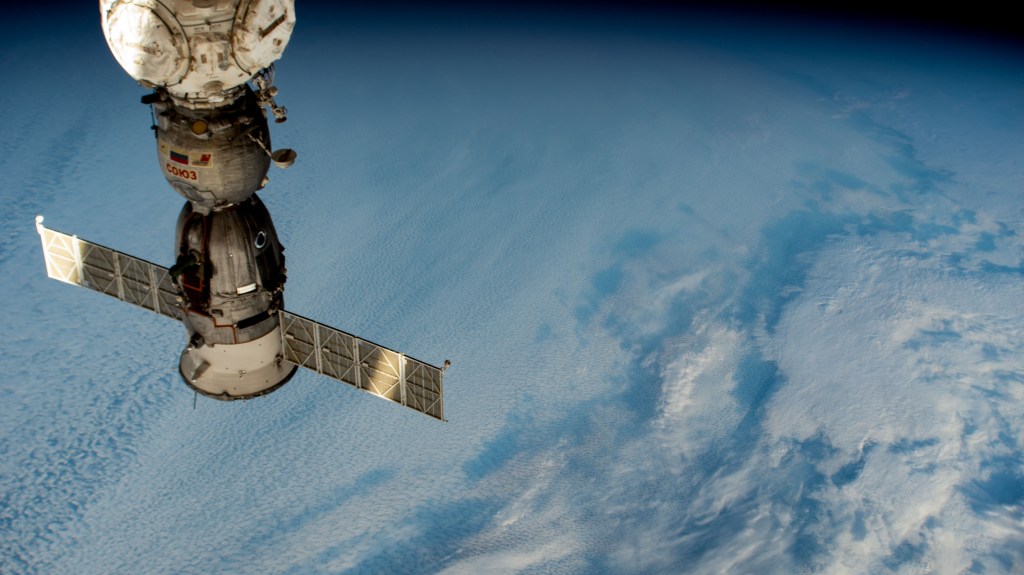 The Soyuz MS-25 crew ship is pictured docked to the International Space Station's Prichal docking module, where it has remained since March 25, 2024, as it soared 274 miles above a cloudy Indian Ocean.