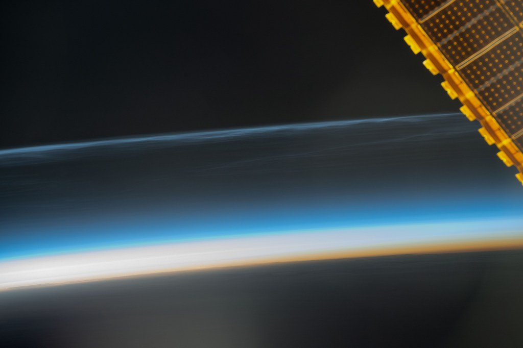 Noctilucent clouds, high-altutude clouds visible during the summer months and illuminated when the sun is below Earth's horizon, are pictured from the International Space Station as it orbited 259 miles above the Pacific Ocean south of Alaska.