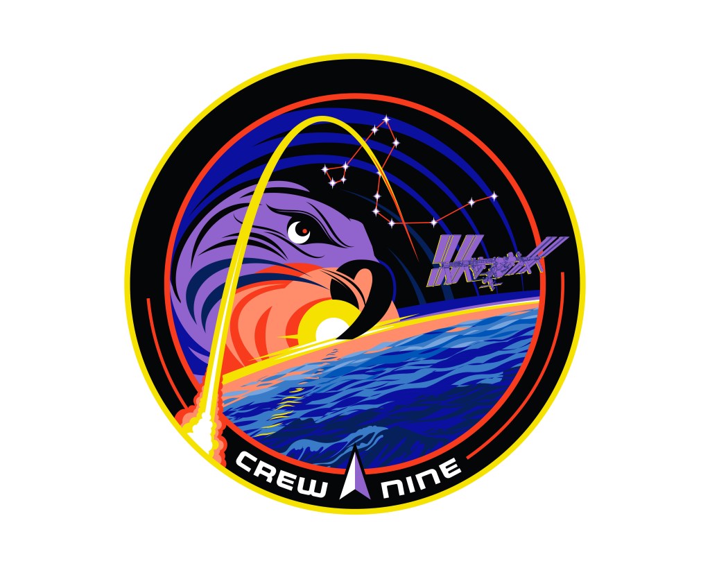 The Crew-9 mission patch depicts the trail of a rocket launching en route to the International Space Station, which will be home for a long-duration expedition dedicated to service, science, and collaboration. Coastal waves are inspired by the historic Florida launch site, and on a larger scale represent our blue planet, the global ocean connecting all continents. A falcon, with the number nine as its beak and a crescent moon as its eye, is a nod to the Falcon 9 rocket, while the constellation Draco honors the Dragon spacecraft that will take Crew-9 to their destination. The Delta symbol, first used in 1961, evokes historic ties to the earliest days of space endeavors. Human exploration of space is built on international collaboration and depends on the support of multitudes across the globe whose efforts honor that heritage.