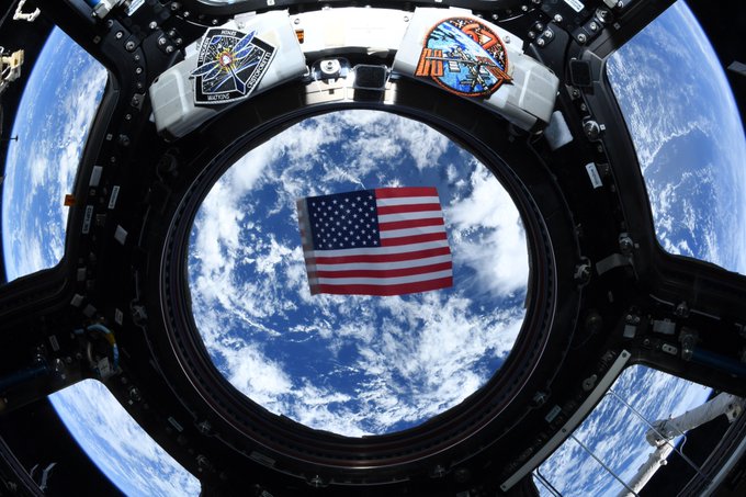 The Expedition 67 crew photographed the American flag and its patches in the space station's Cupola