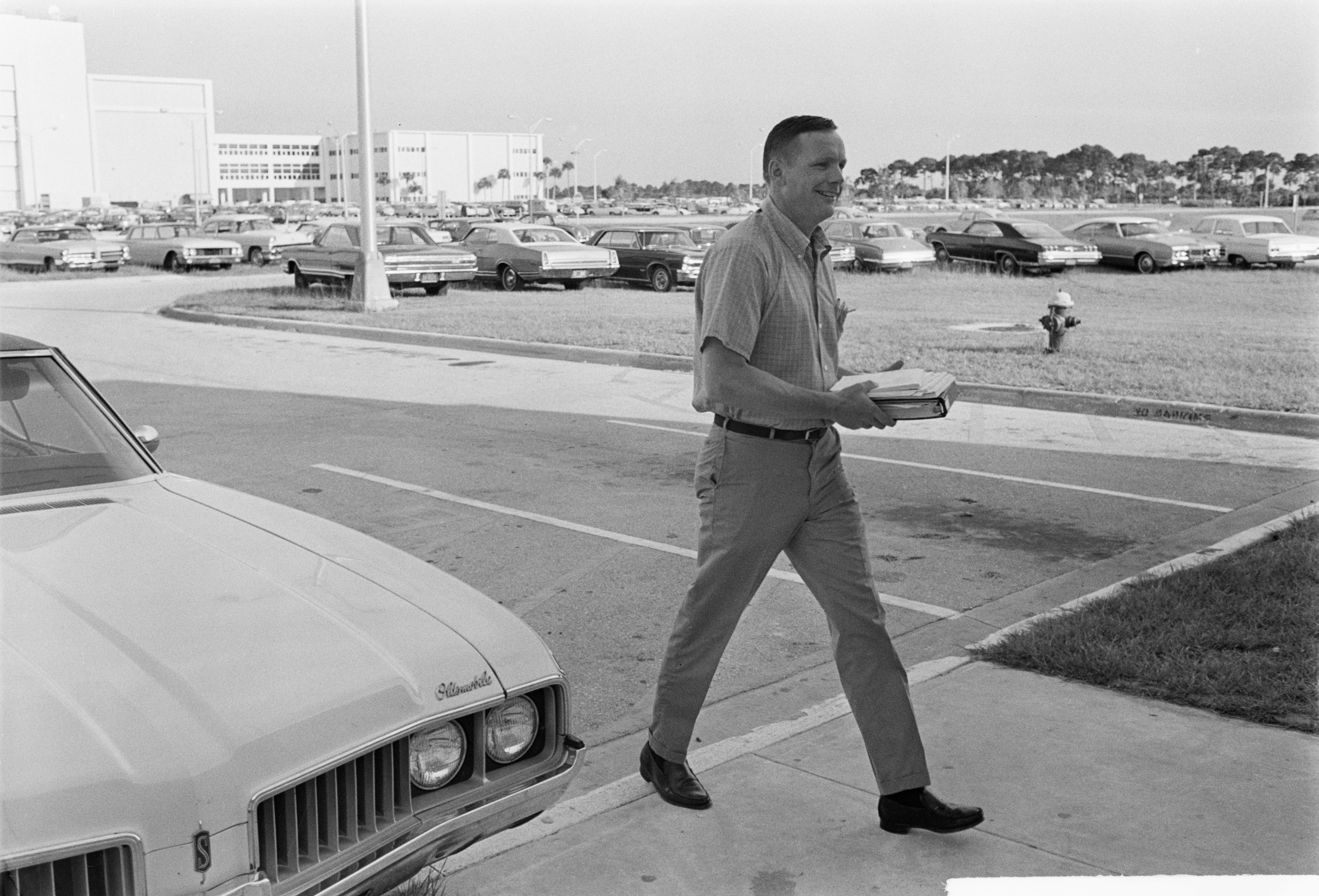 Apollo 11 astronaut Neil A. Armstrong arrive for work at NASA's Kennedy Space Center in Florida four days before launch