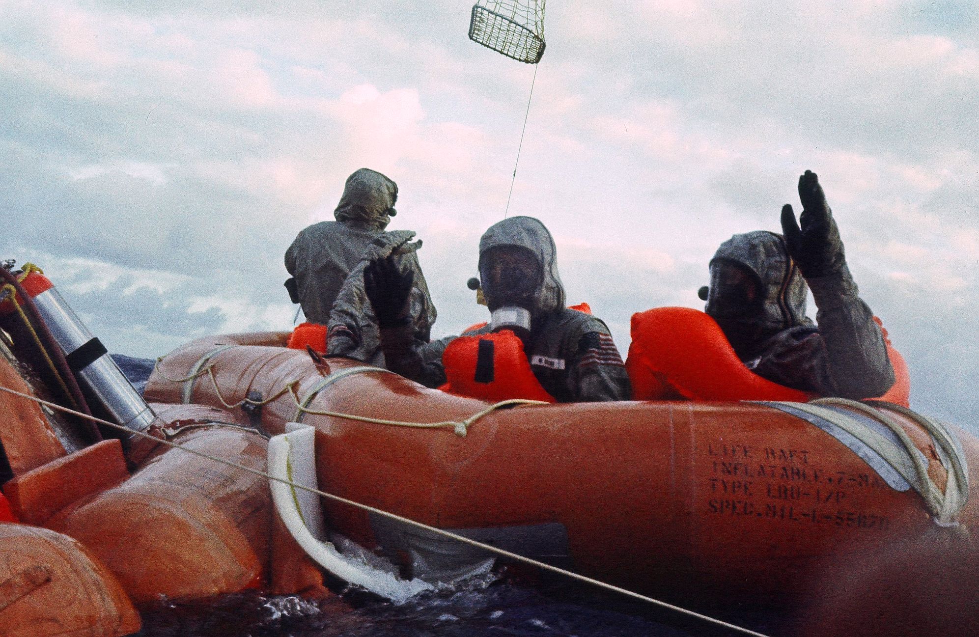 Taken by U.S. Navy UDT swimmer Mike Mallory in a nearby raft, Hatleberg prepares to capture the Billy Pugh net for Neil, while Buss and Mike wave to Mallory