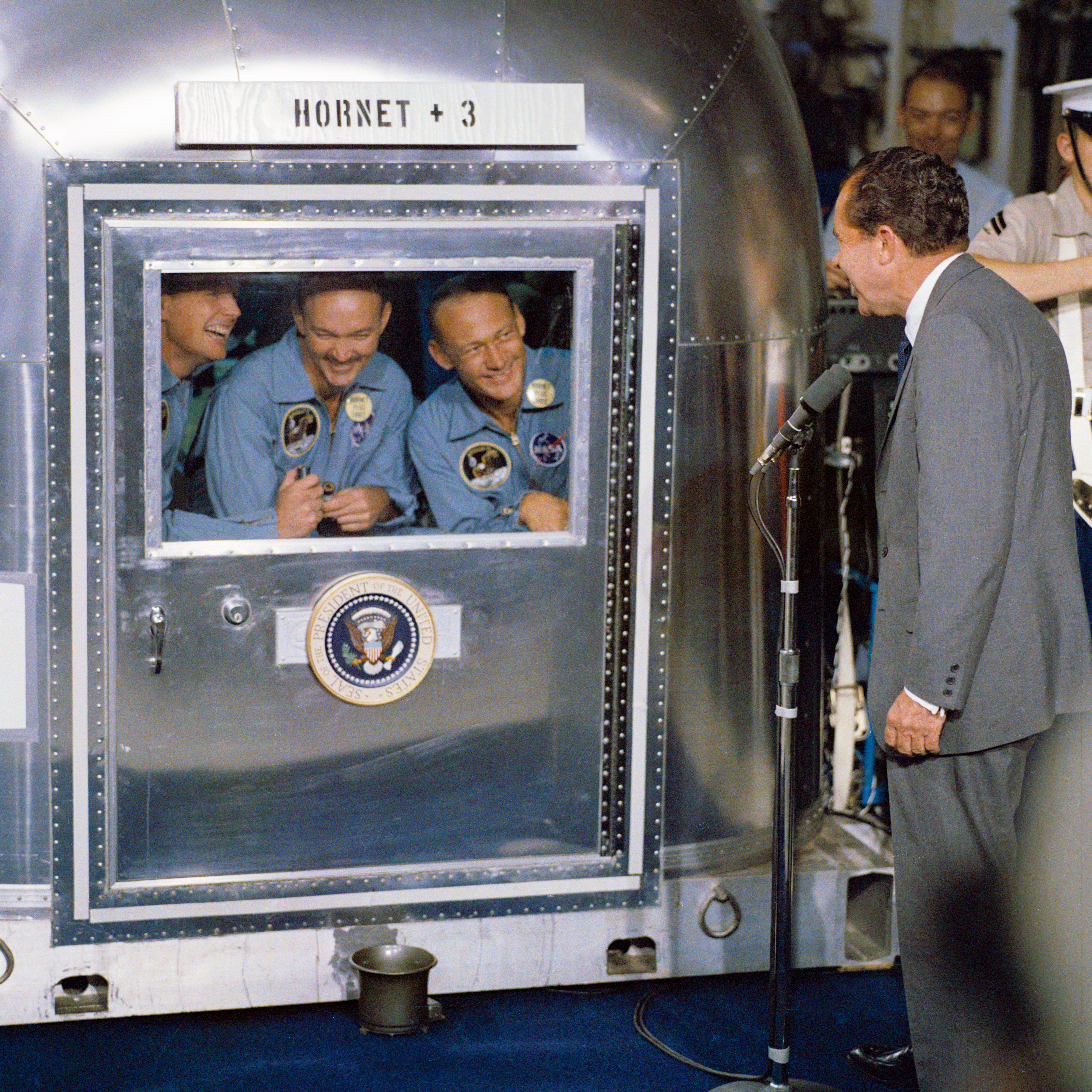 Changed from their BIGs into flight suits, Mike, Neil, and Buzz chat with President Nixon through the MQF’s window