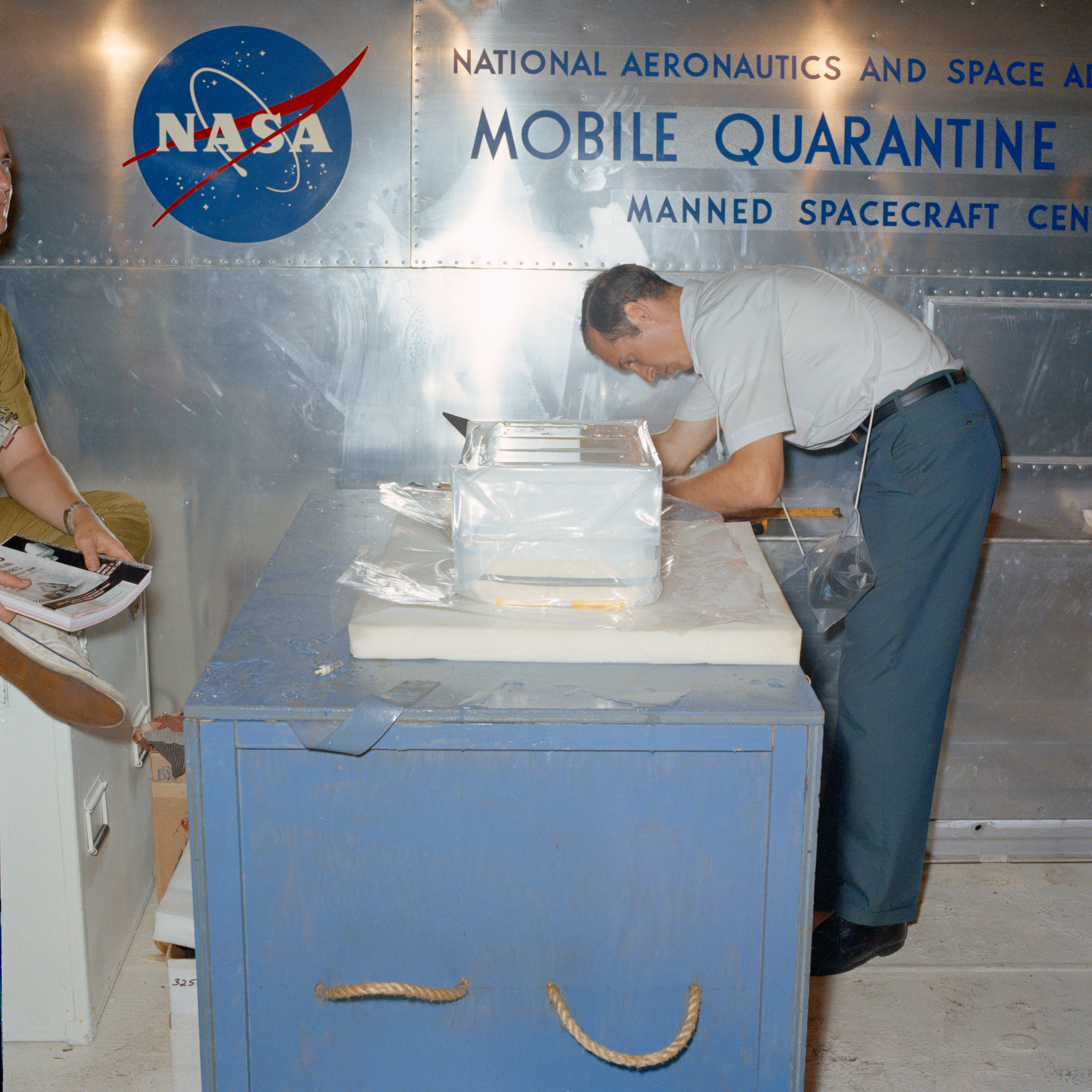 NASA technician receives the first box of Moon rocks from the MQF's transfer lock