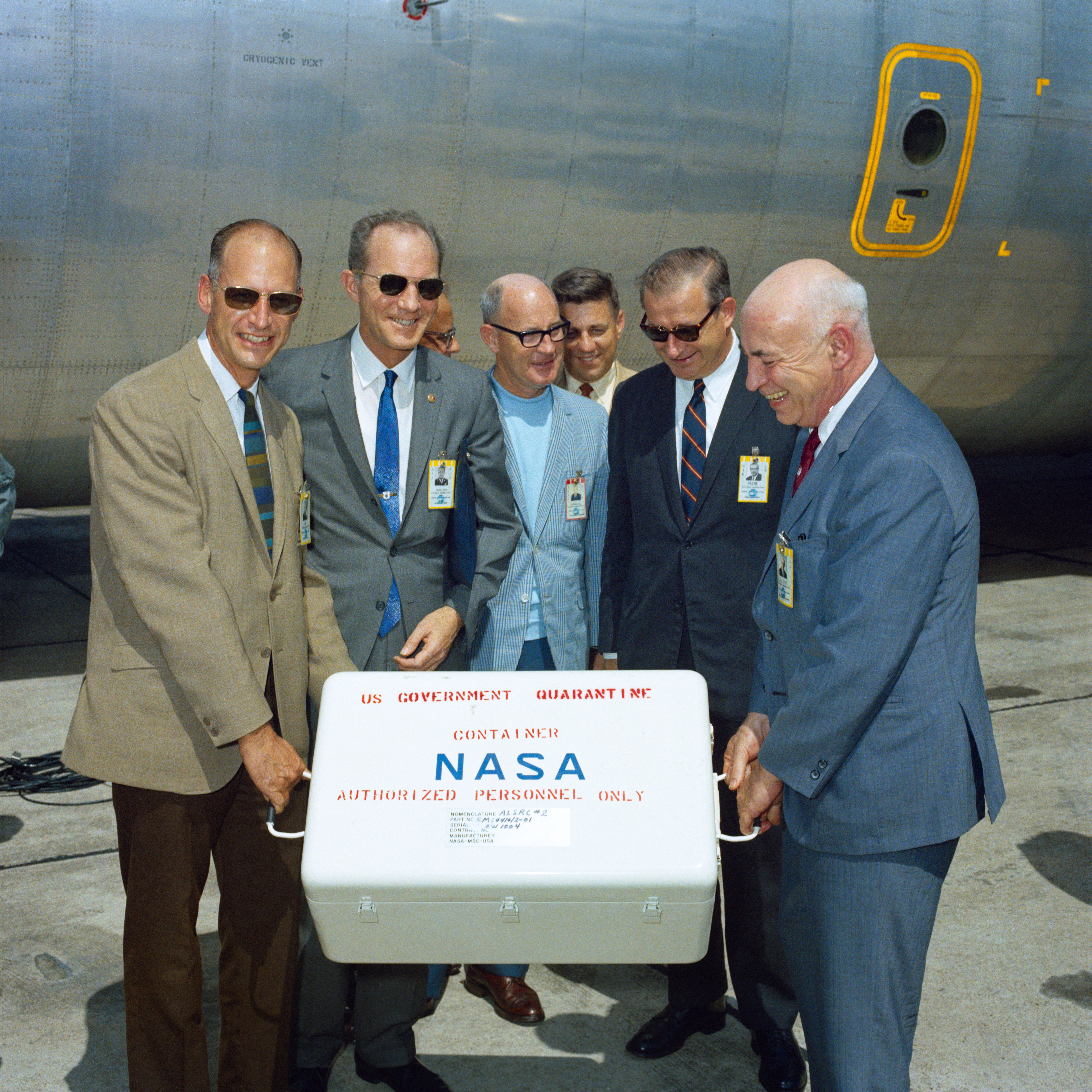Senior NASA managers hold the first box of Moon rocks