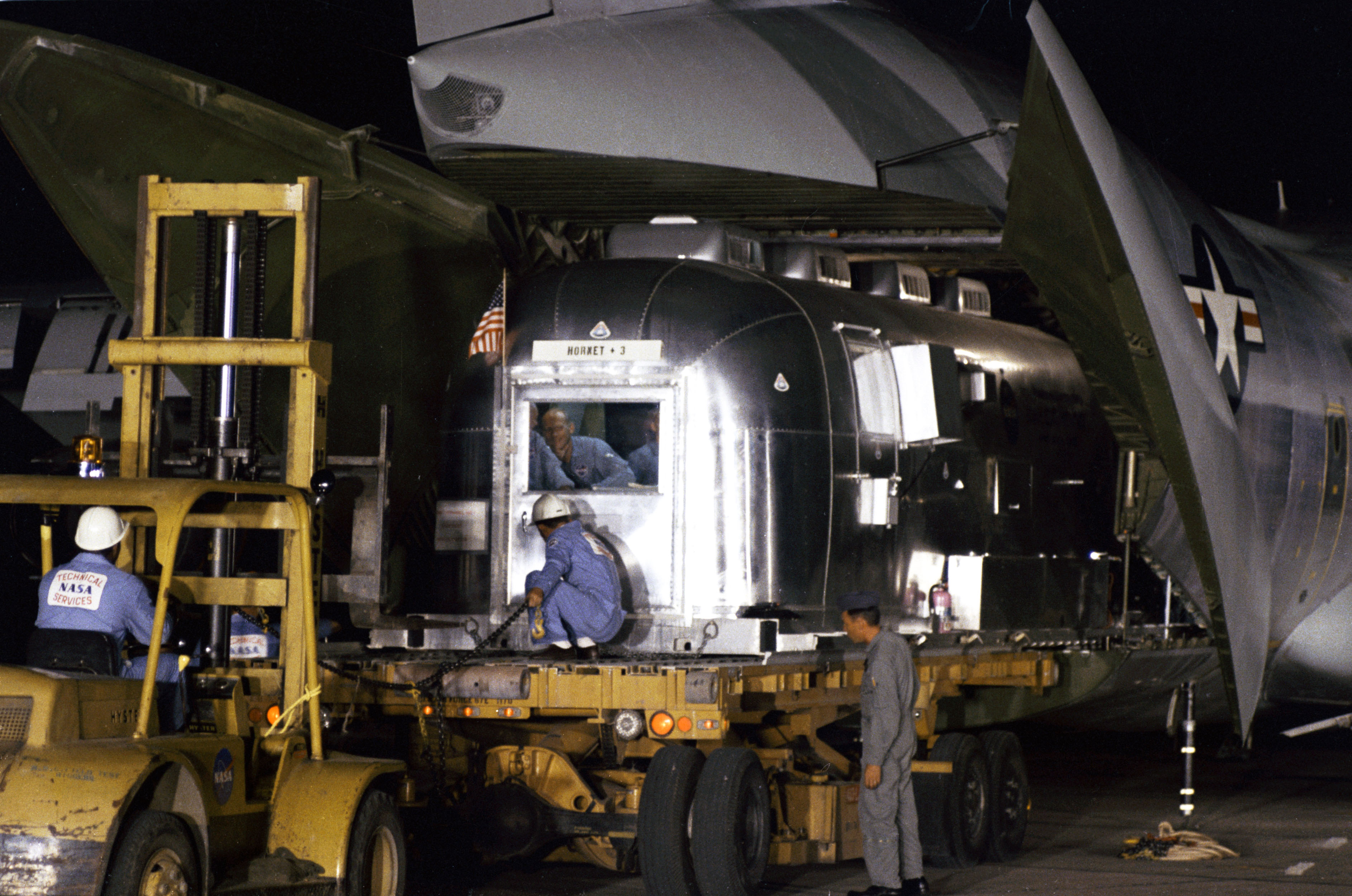 Workers unload the MQF at Houston’s Ellington AFB