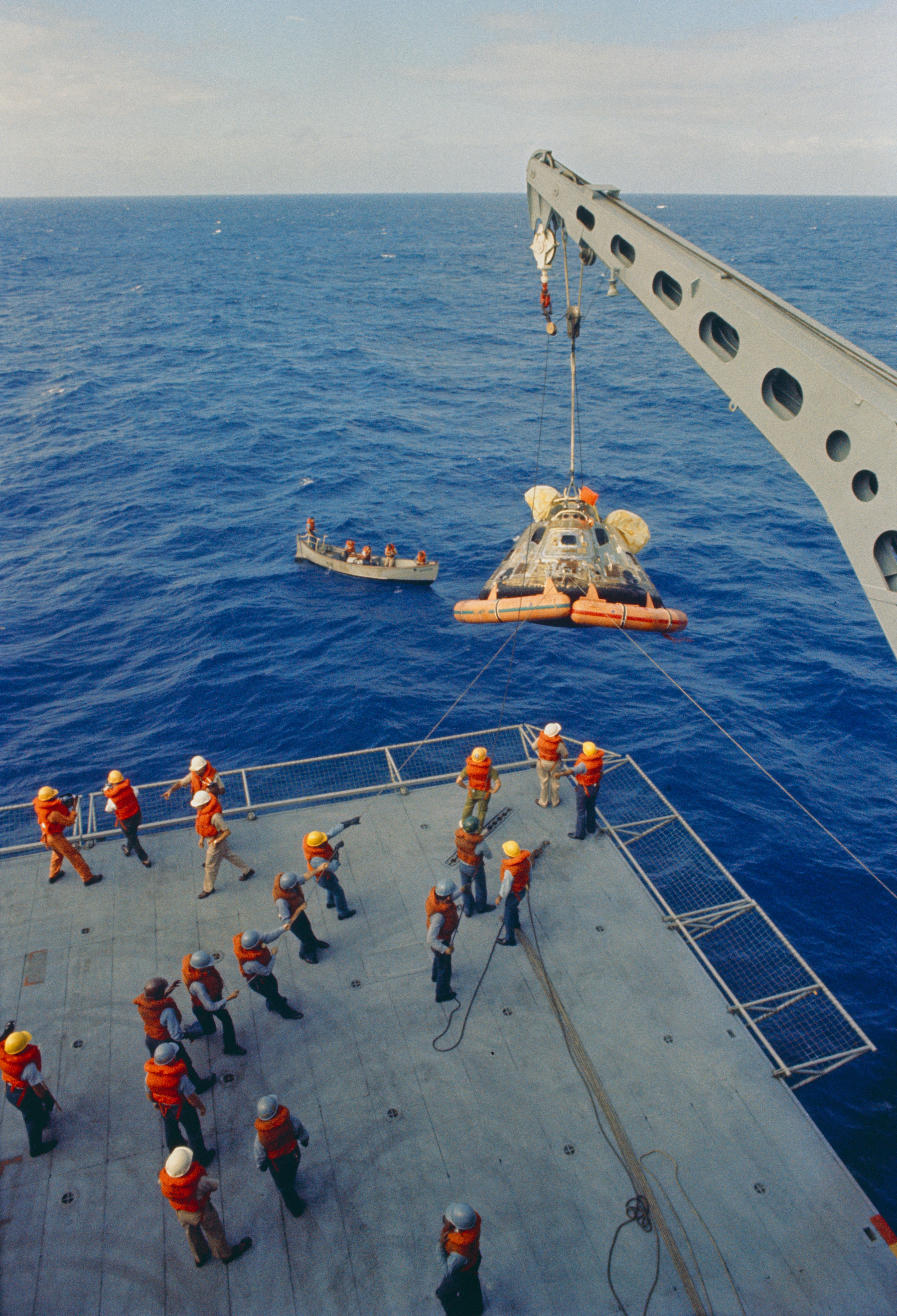 Sailors hoist the Command Module Columbia onto the deck of the U.S.S. Hornet
