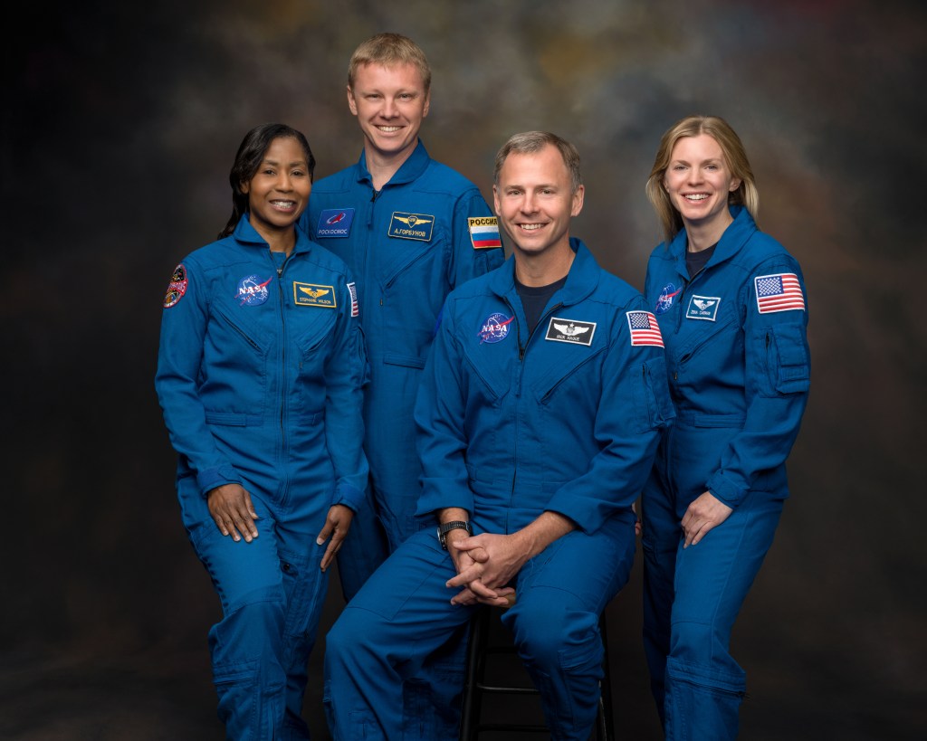 Members of NASA's SpaceX Crew-9 mission pose for a photo in their blue flight suits.