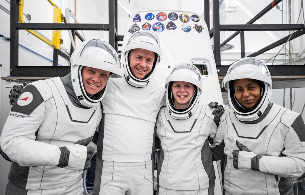 Members of NASA's SpaceX Crew-9 mission pose for a photo in their SpaceX spacesuits at SpaceX headquarters in Hawthorne, California.